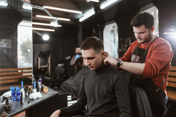 shave neck/ Barber cutting in barbershop. Shaves the man's neck with a blade