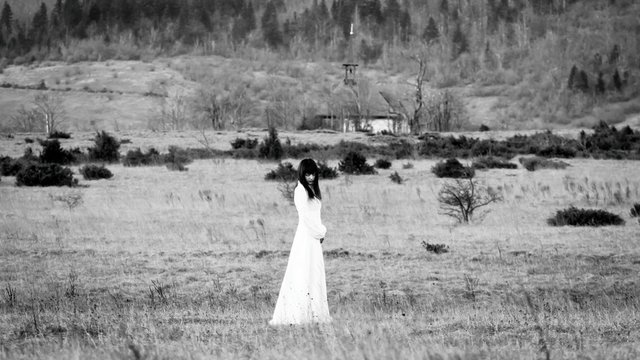 Horror scene of a scary woman in long white dress