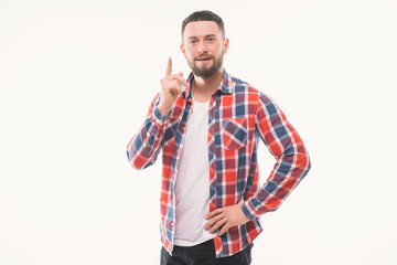 Portrait of a smiling satisfied man in plaid shirt pointing at camera isolated on a white background