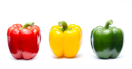 three colors of sweet bell pepper on white background ( Capsicum annuum., SOLANACEAE )