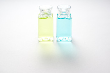 Mini bottle of shampoo and shower bath on space of white background with shading