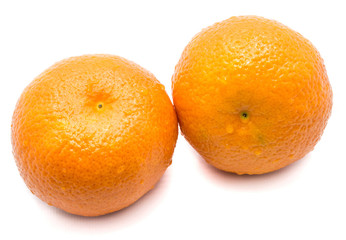 Two whole Clementines with water drops isolated on white background