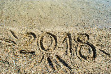 2018 written in the beach surface