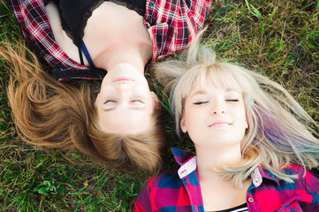 Girlfriends lying down on a grass