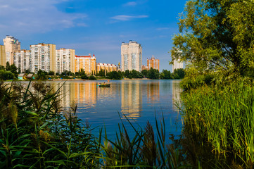 Fototapeta premium Modern buildings around the Verbne lake in the Obolon district of Kiev, Ukraine