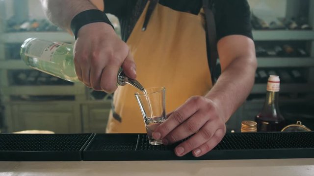 bartender prepares B52 Shot, cocktail preparation in modern bar with fire, tequilla vodka rum gin