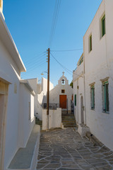 Fototapeta na wymiar Street in Lefkes, Paros, Greece on a sunny summer day, vertical