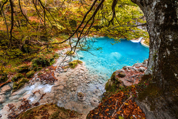 colorful autumn landscape at urederra source, Spain