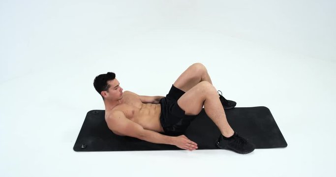 sport, bodybuilding, lifestyle and people concept - young man making abdominal exercises. Red Epic.