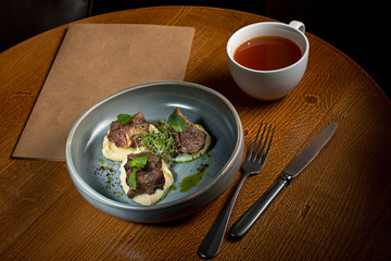 Grilled steak with vegetables puree on plate.