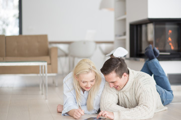 Young Couple using digital tablet on cold winter day