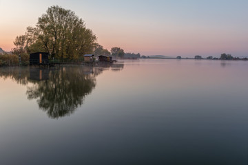 Obraz premium French countryside - Lorraine. A small lake with fisherman's hut at sunrise.