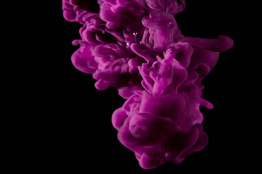 Purple Paint Drops In Water. Ink Swirling Underwater.