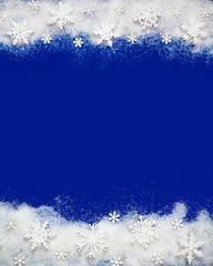 Christmas background with a decorative snowflake on artificial snow