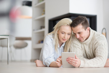 Young Couple using digital tablet on cold winter day