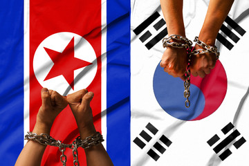 The hands of the chains against the background of the flag of North Korea, DPRK, South Korea