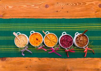 Finnish traditional Christmas table.potato, carrot, chestnut, red cabbage and liver casserole, ham and the vinaigrette Top view. Rustic style