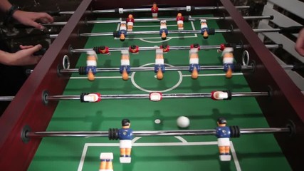 The game of table football. The game of table football. - Powered by Adobe