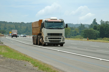 Fototapeta na wymiar large white dump truck and other vehicles