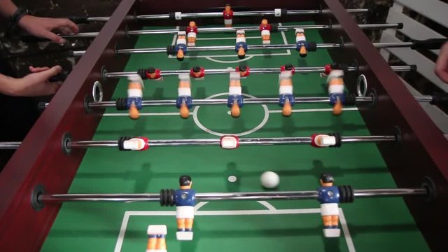 The game of table football. The game of table football.