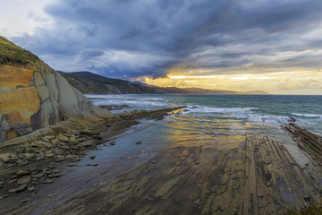 Itzurun beach is  known locally as the flysch at sunset near Zambia small town in Northern Spain
