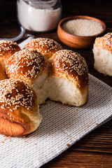 Bread with sesame seeds on a wooden background.