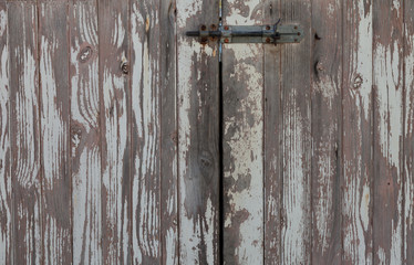 Closeup of weathered  rustic doors in subtle greys