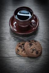 vertical view cup coffee saucer on wooden board cookies