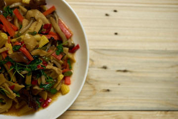 closeup vegetarian fired basil on wood table