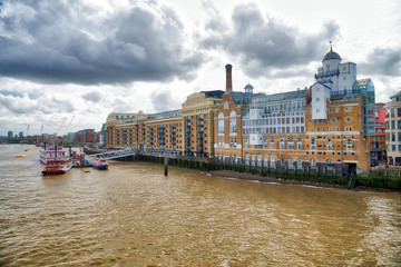 LONDON - SEPTEMBER 25, 2016: City skyline along Thames river. London attracts 30 million tourists annually