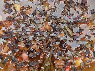 Tea of different kinds is poured into light cups.