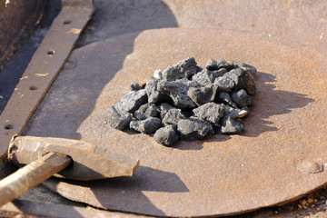 coal in the rusty brazier of a blacksmith