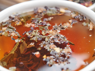 Tea of different kinds is poured into light cups.