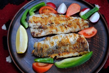 Fish hake cooked in a grill pan at home. Grilled fish