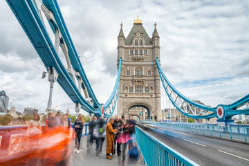 Fototapeta na wymiar Tourists along Tower Bridge in London, blurred view with long exposure