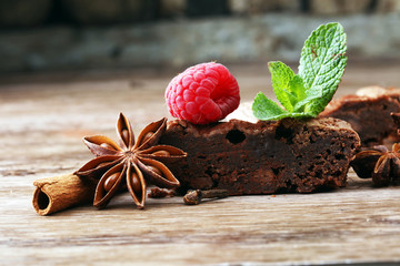 chocolate brownie cake dessert with cinnamon and spices on a wooden background.
