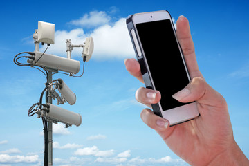 Cellular network antenna and handphone and blue sky.