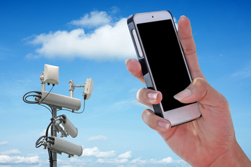 Cellular network antenna and handphone and blue sky.