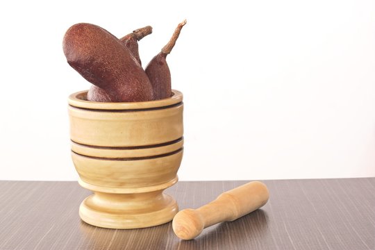 Carob fruit in mortar