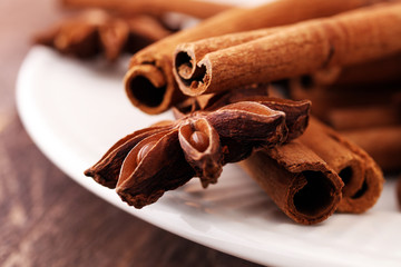 Fragrant star anise and cinnamon on wooden table.