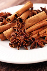 Fragrant star anise and cinnamon on wooden table.
