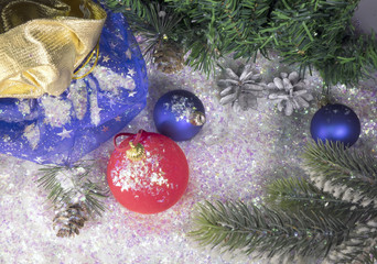 and blue New Year's ball on decorative snow and a bag with gift