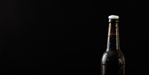 Closeup of a beer bottle isolated on black background