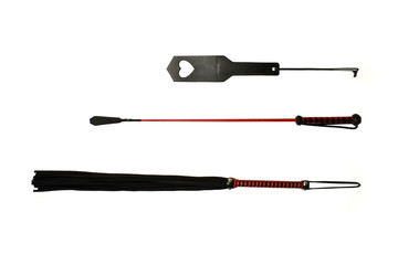 Leather flogger, paddle and whip collection stock photo images. Spanking tools isolated on a white...