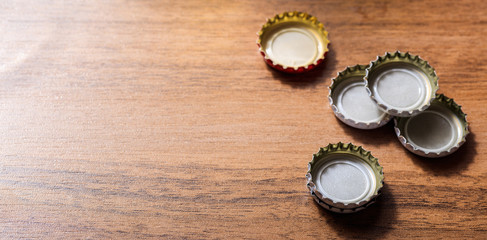 Beer caps on wooden background