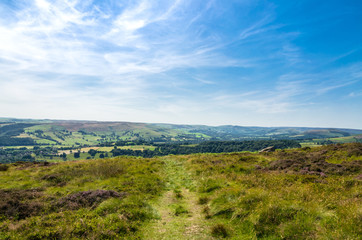 Fototapeta na wymiar A footpath in the romantic Peak District countryside in summer, Derbyshire, England