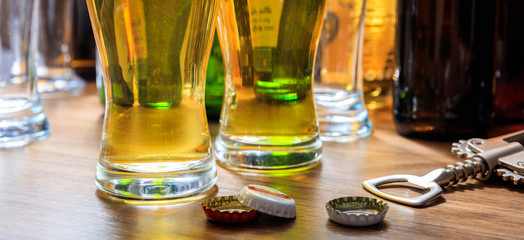 Beer caps and glasses of beer on a pub background