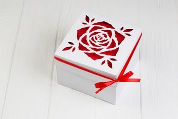 Fototapeta premium White gift box with red ribbon bow. Boxing day