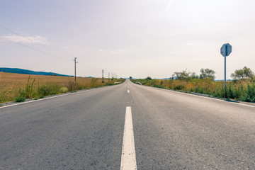Fototapeta premium Asphalt road receding into the distance.