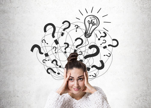 Stressed woman with a bun, light bulb, quesitons